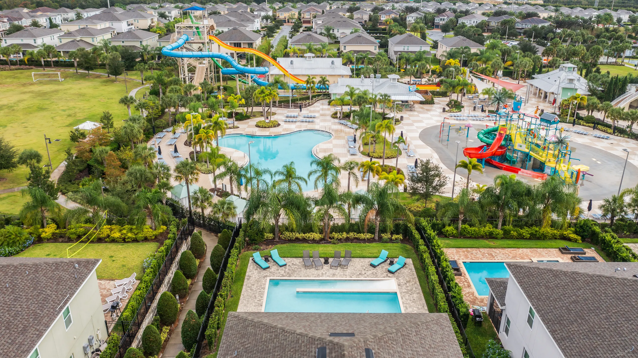 Aerial view showing the villa's pool backing directly onto the Encore Aqua Park