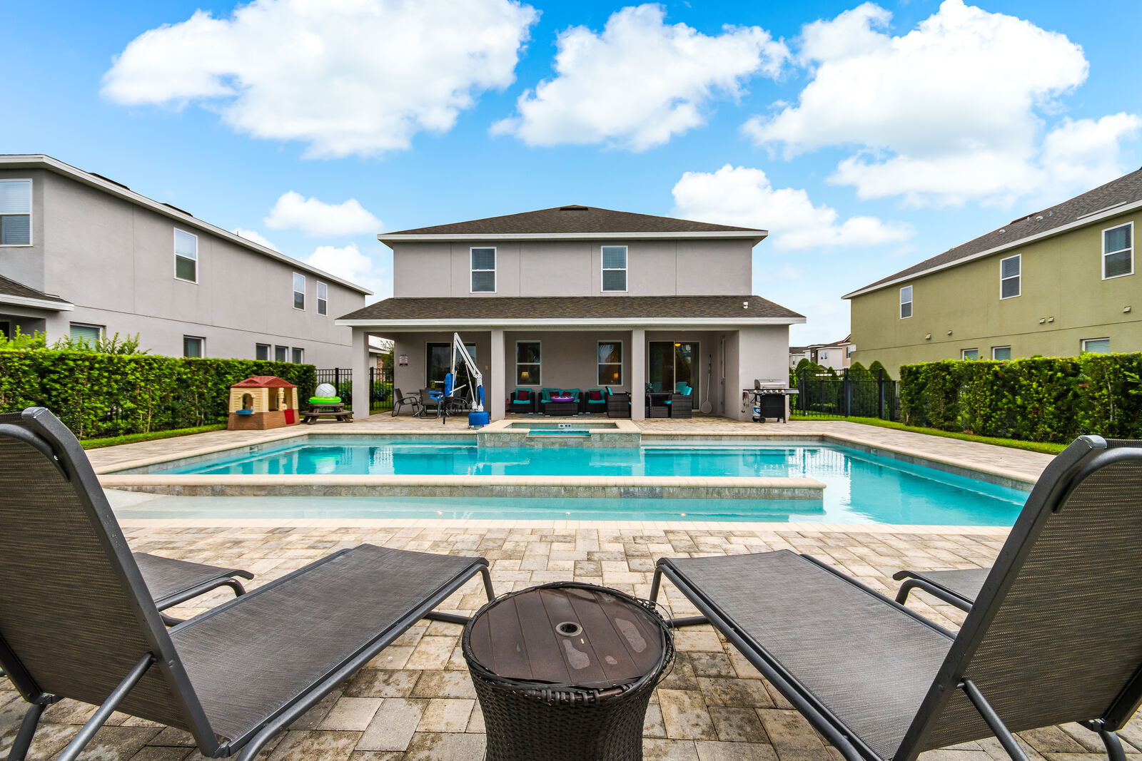 Pool deck at Caesar Falls Villa with loungers and umbrellas